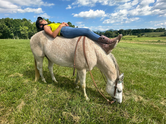 Girl laying on horses back